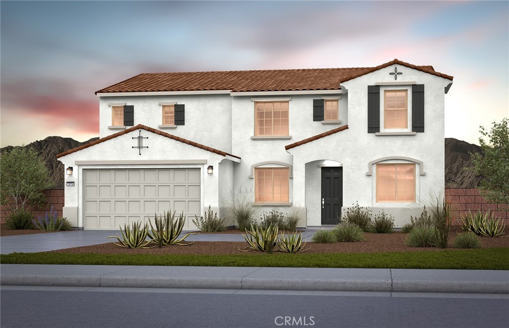 a front view of a house with a garden and garage