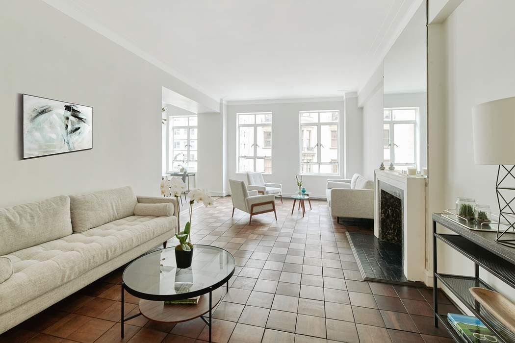 a living room with furniture and a potted plant