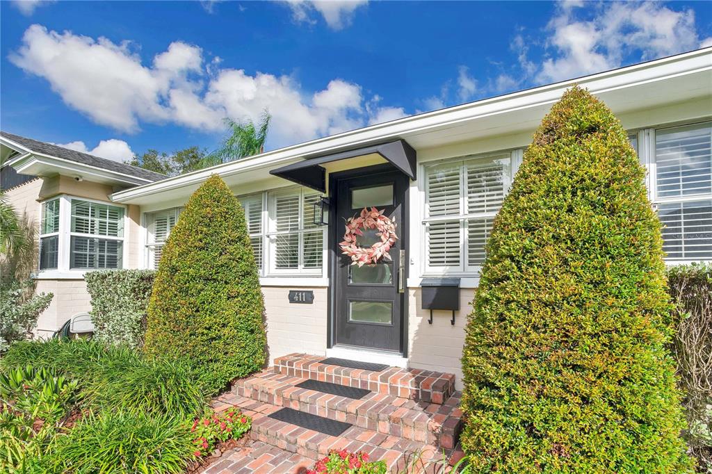 a front view of a house with a garden