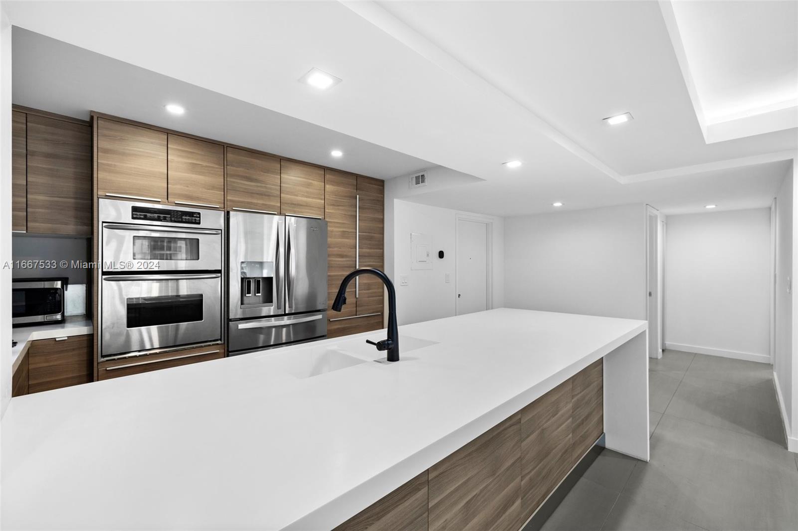 a kitchen with stainless steel appliances a sink and stove