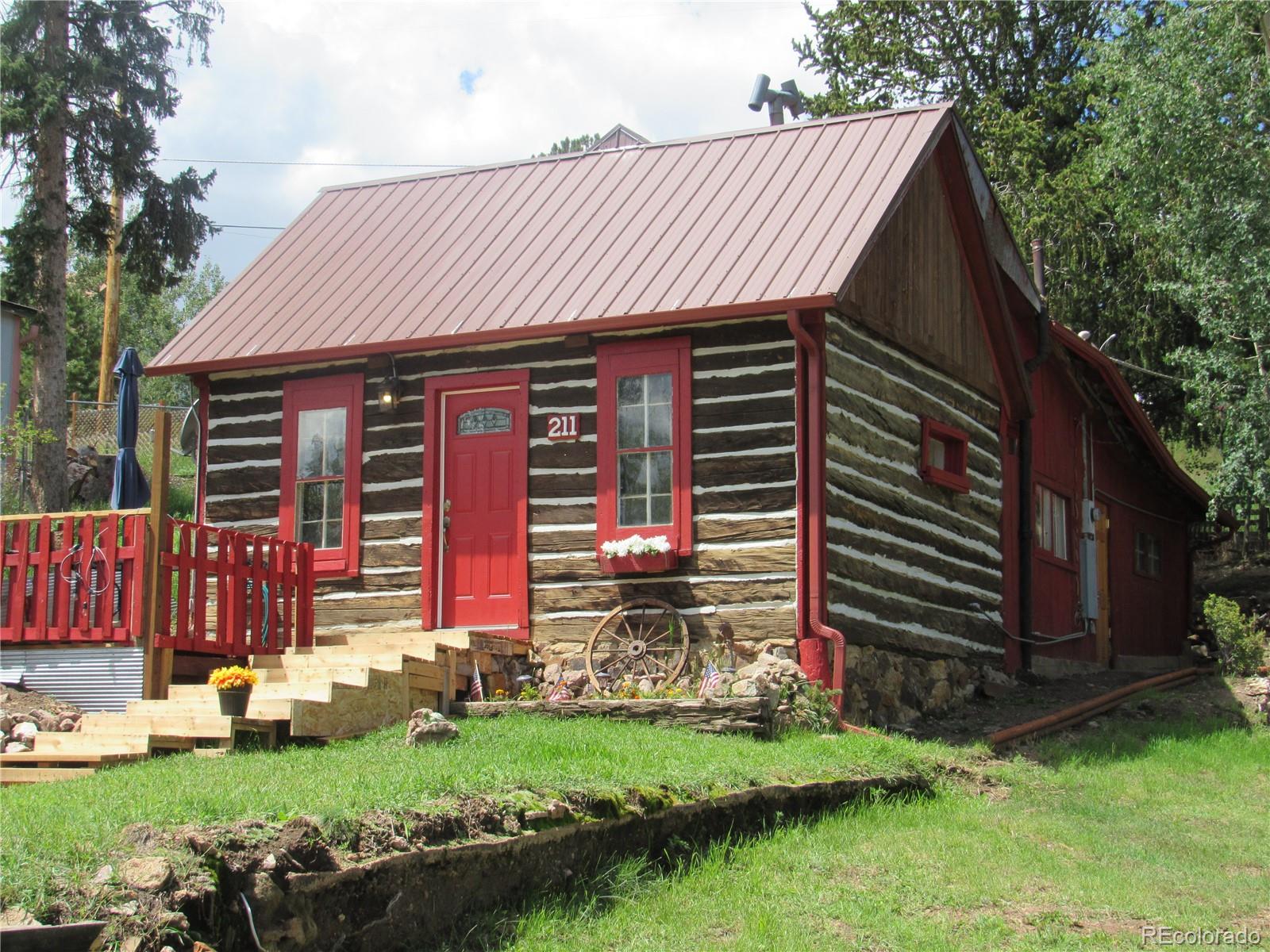 a front view of a house with a garden and yard