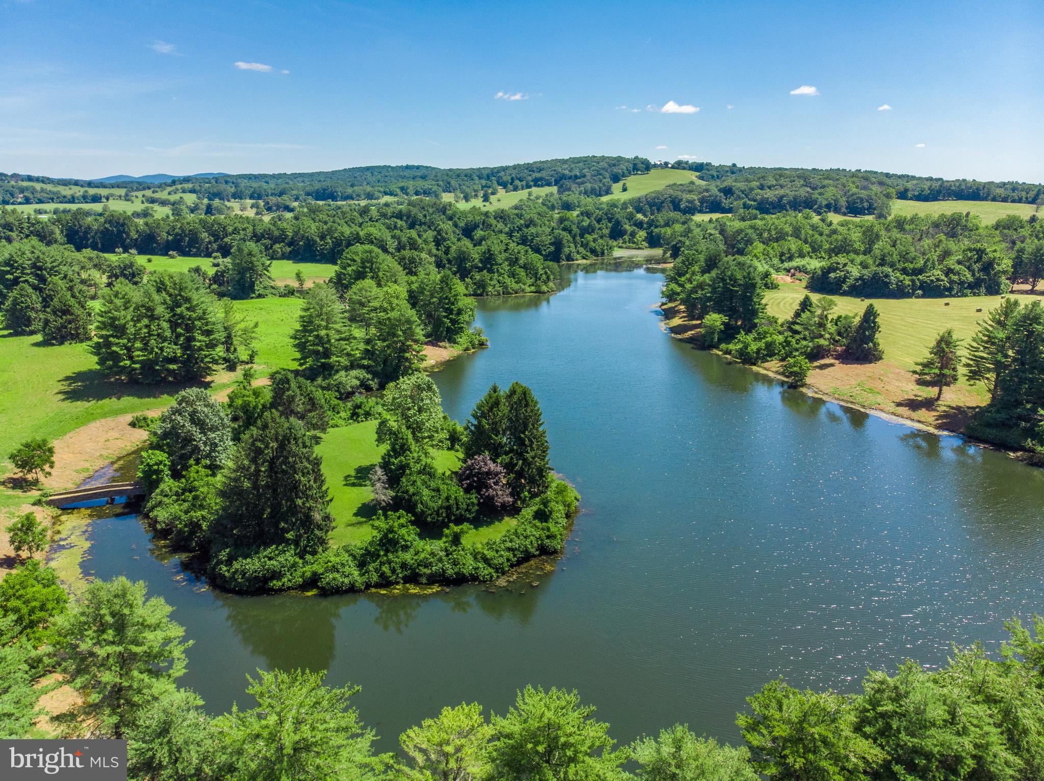 an aerial view of a houses with a lake view