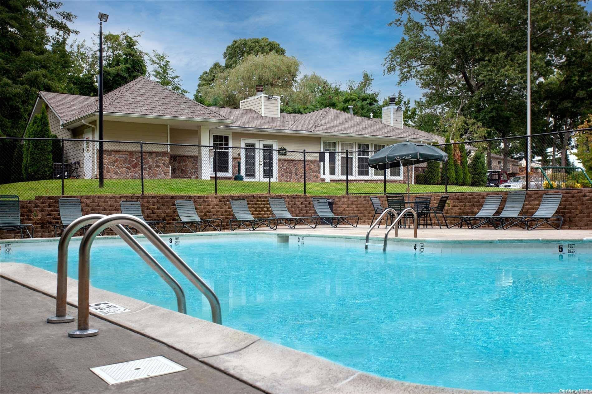 a swimming pool with outdoor seating and yard