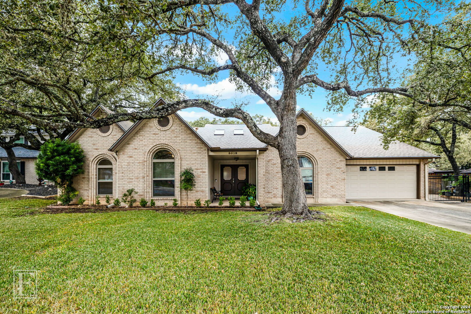 a front view of house with yard and green space