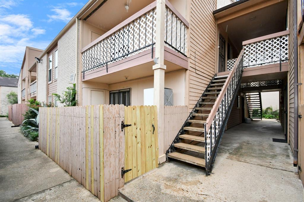 a view of a house with wooden fence stairs