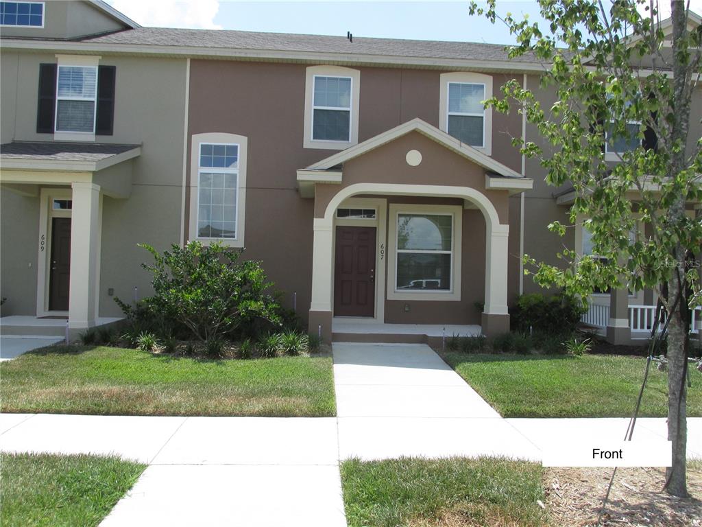 a front view of a house with a yard