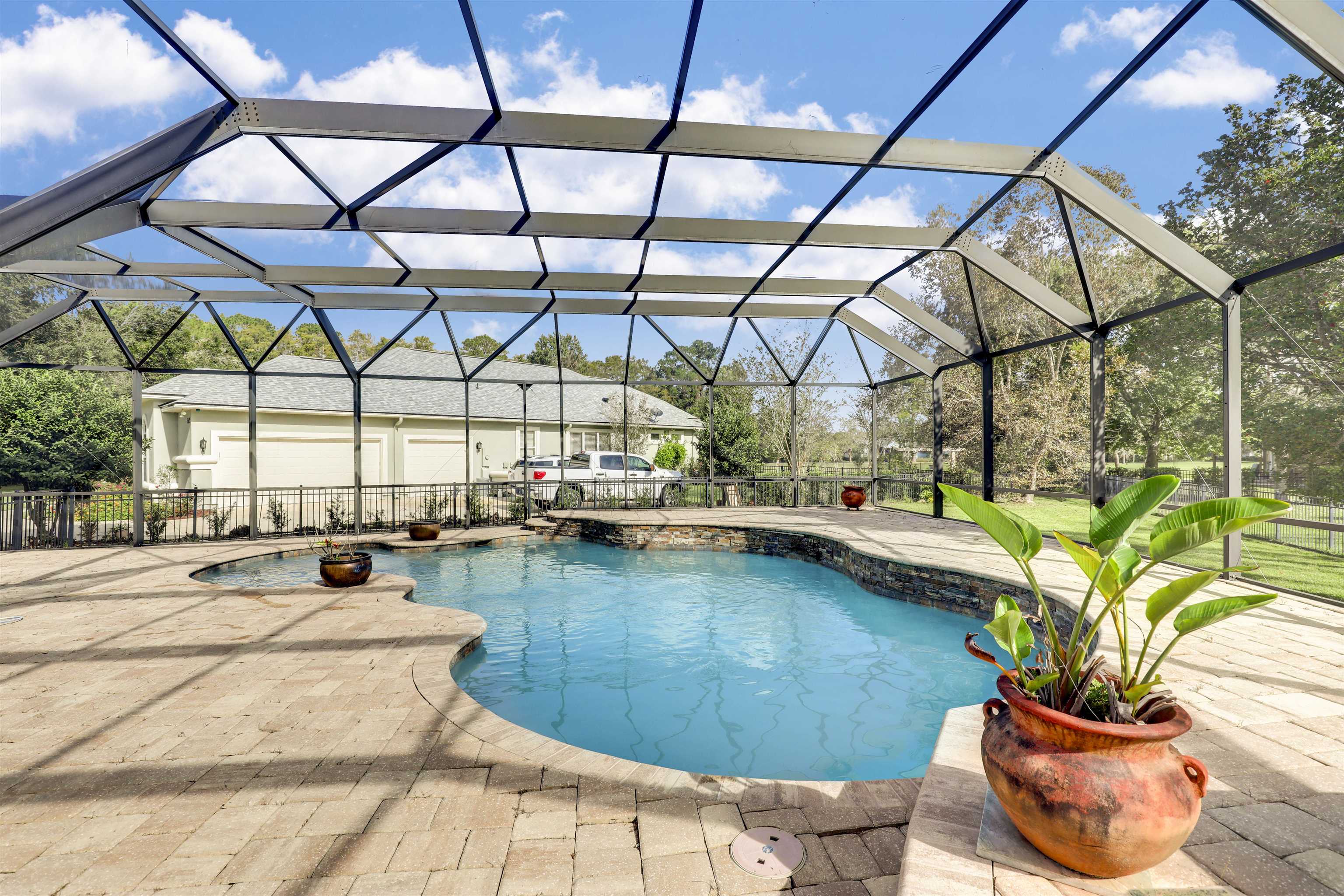 a blue swimming pool with view of lake