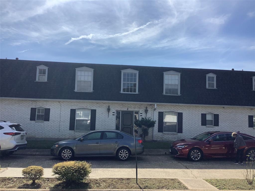 a front view of a house with parking space