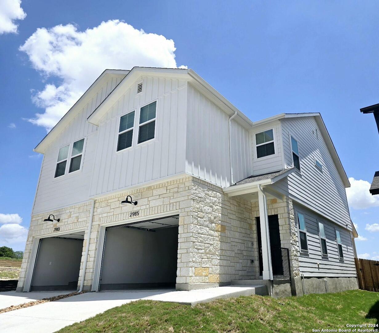 a front view of a house with garage