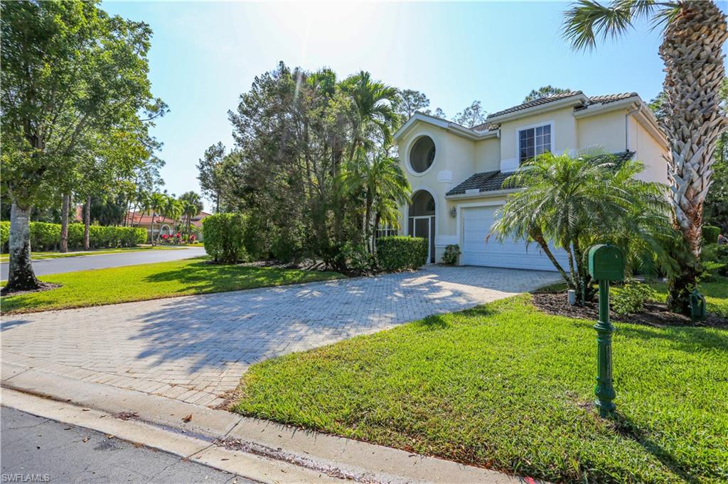 Mediterranean / spanish-style house with a front yard and a garage