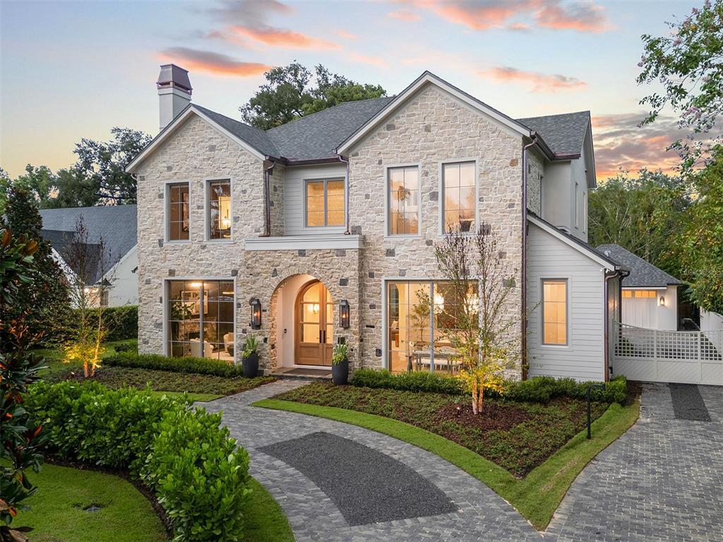 a front view of a house with a garden