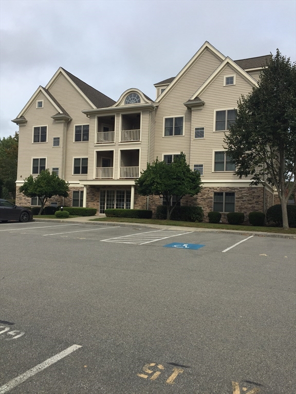 a front view of a house with a road