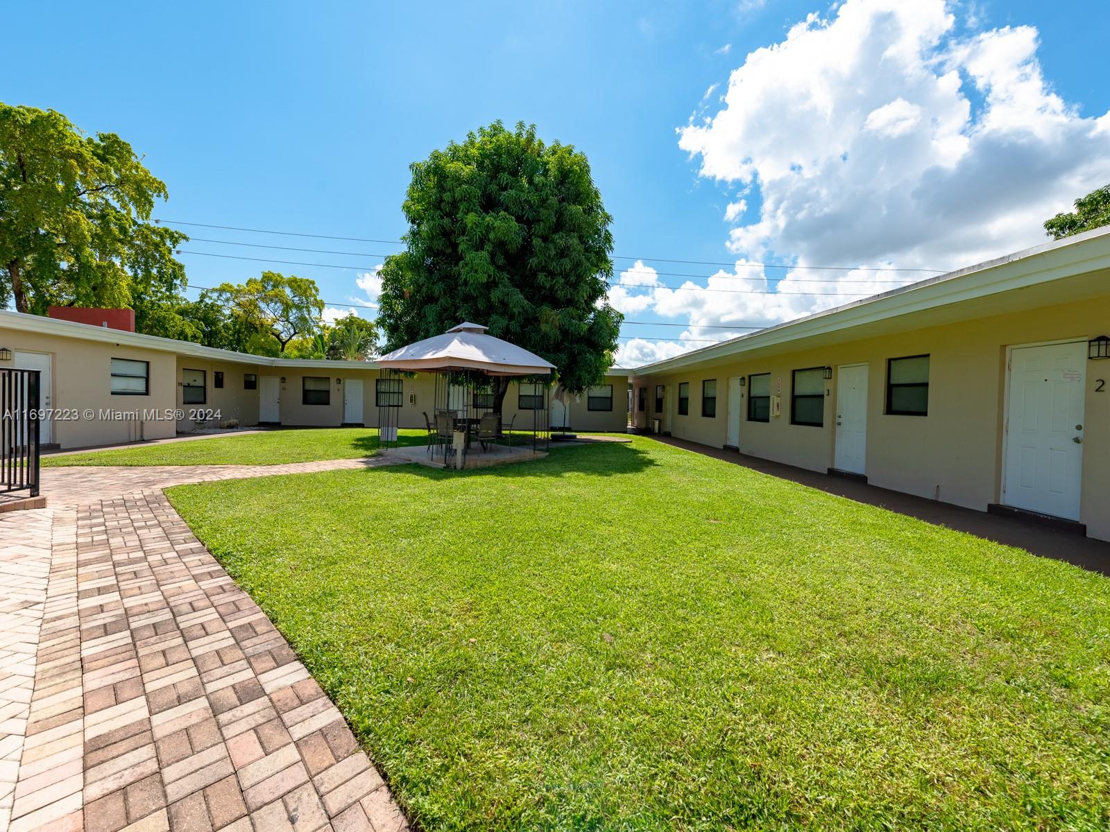 a front view of a house with yard and patio