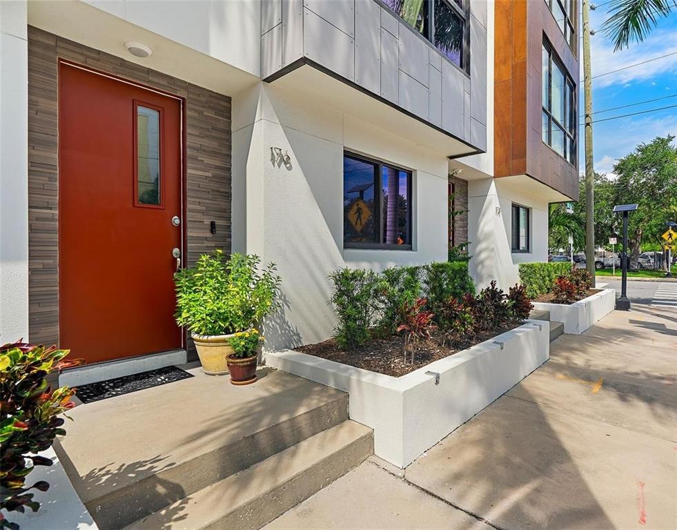 a view of a house with potted plants