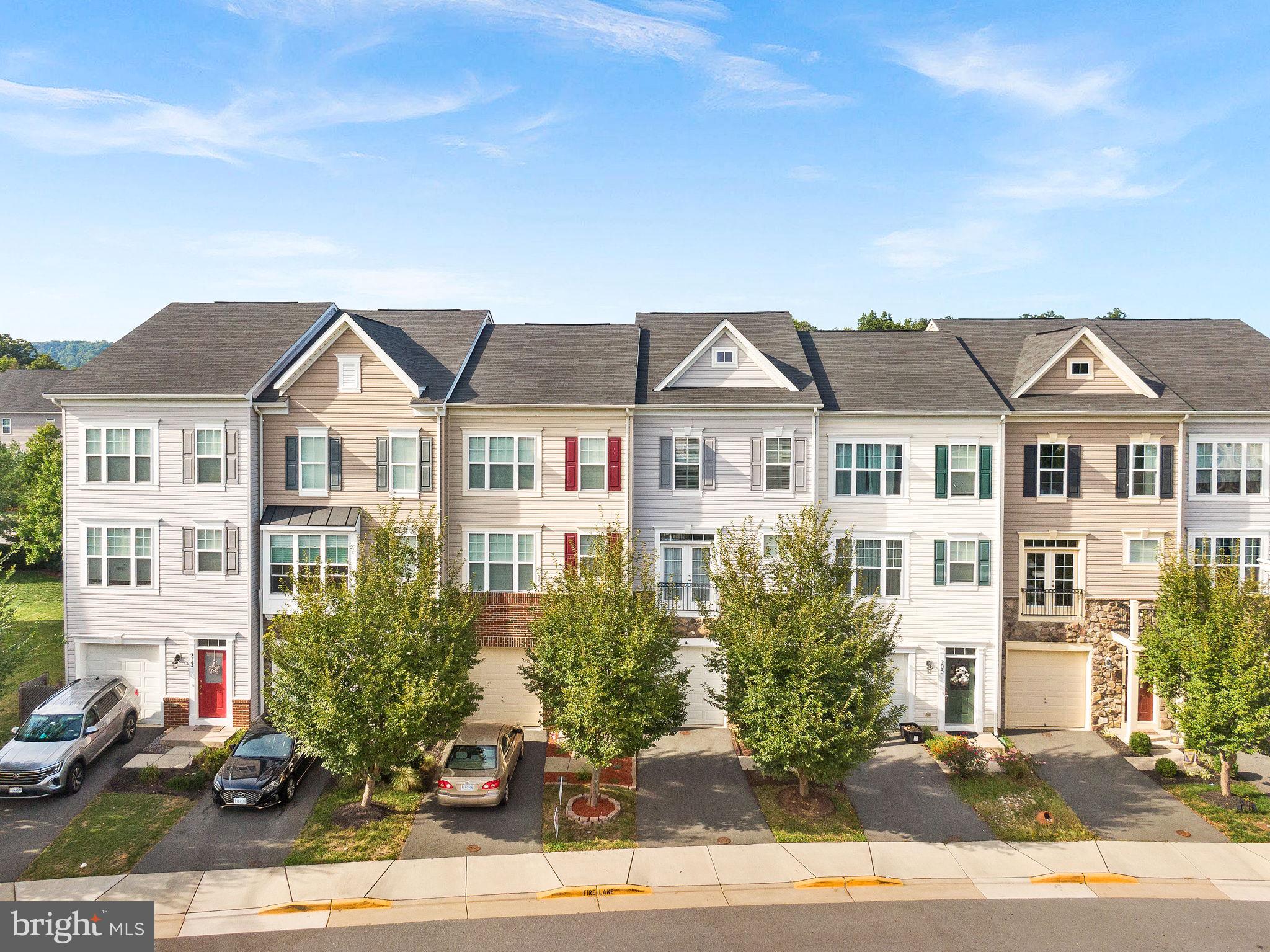 a front view of a residential houses with yard