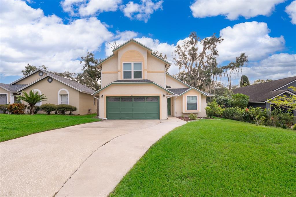 a front view of a house with a yard and garage