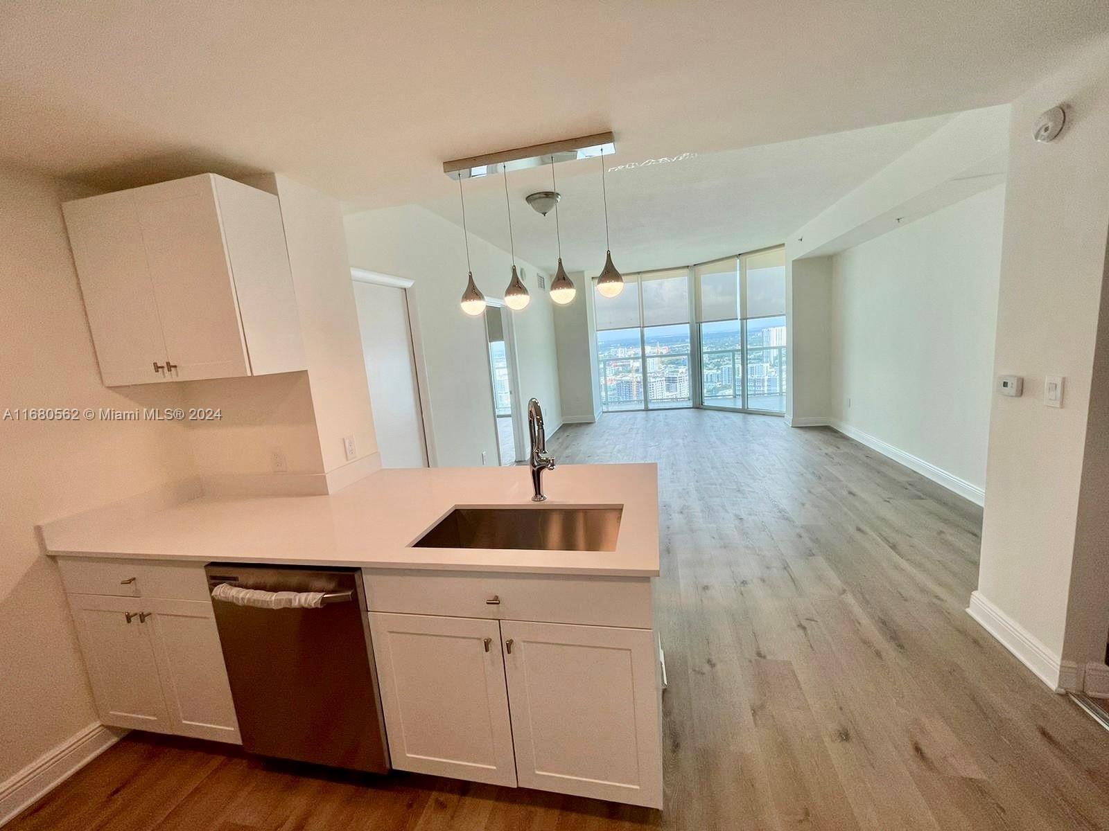 a kitchen with a sink and cabinets