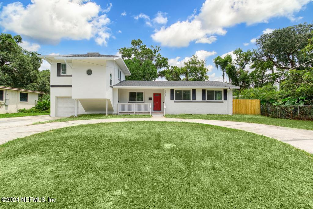 a view of a house with a backyard