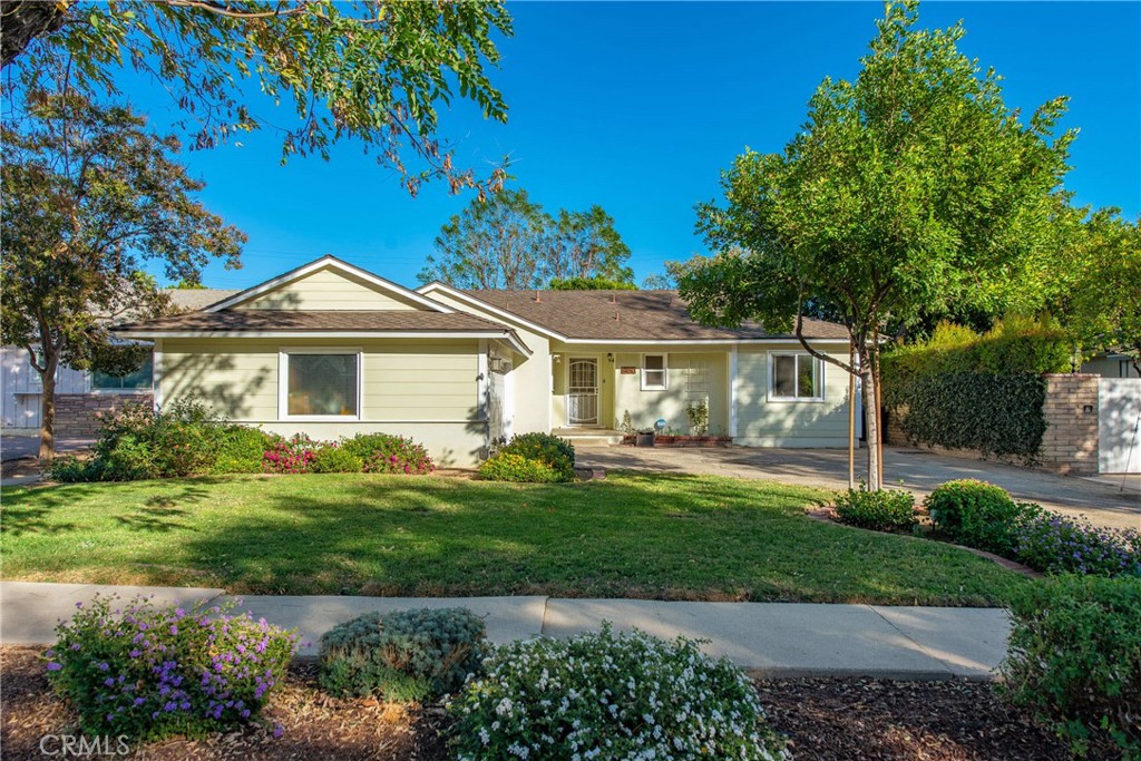 a front view of a house with a garden