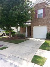 a view of a brick house with a yard