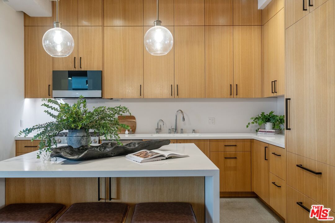 a view of kitchen with a sink and wooden floor