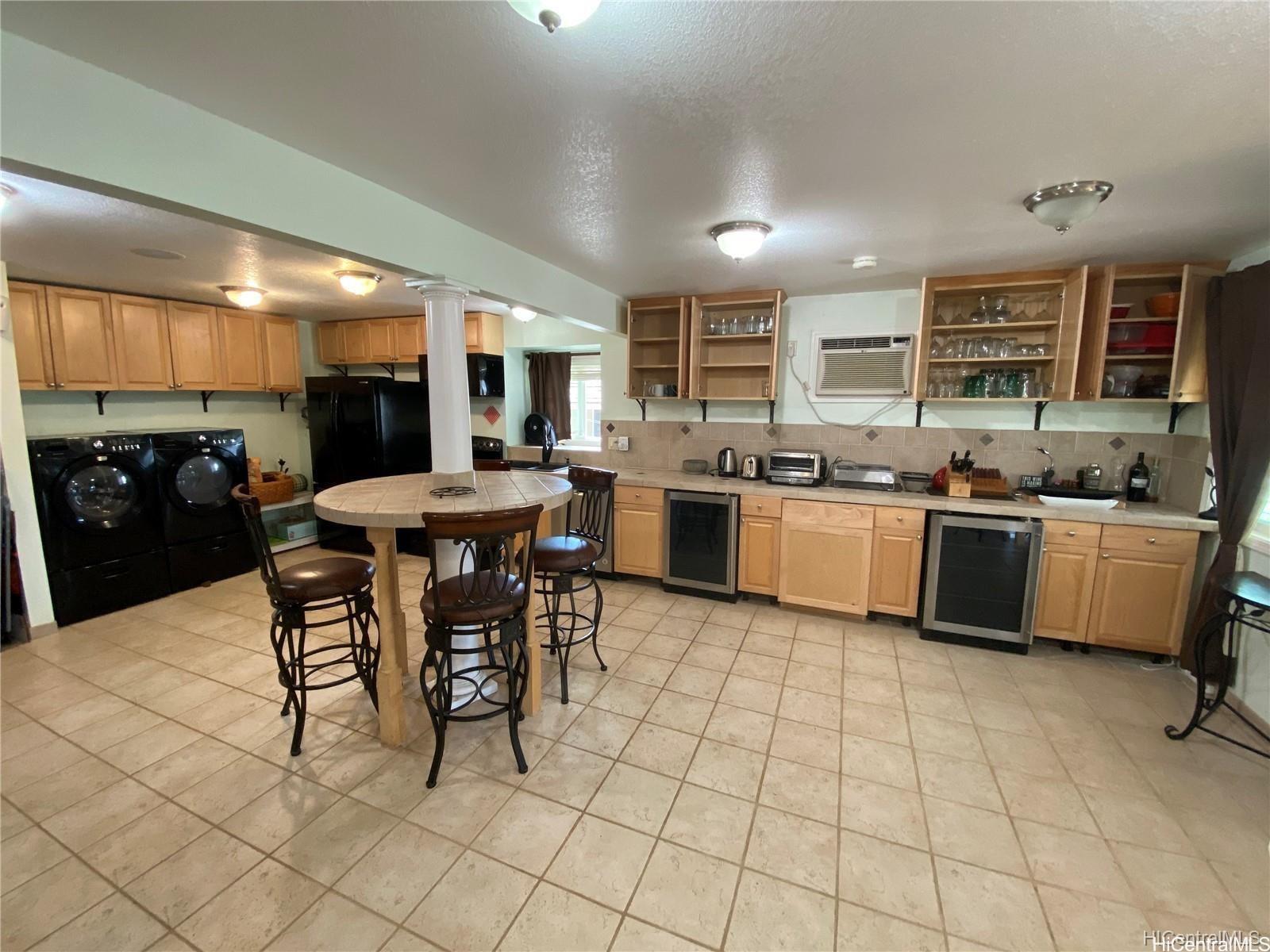 a kitchen with stainless steel appliances a sink a stove a counter top space and cabinets