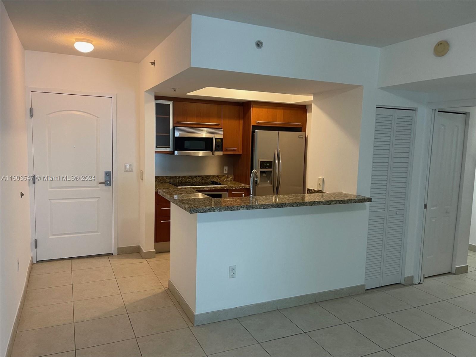 a kitchen with a refrigerator and a stove