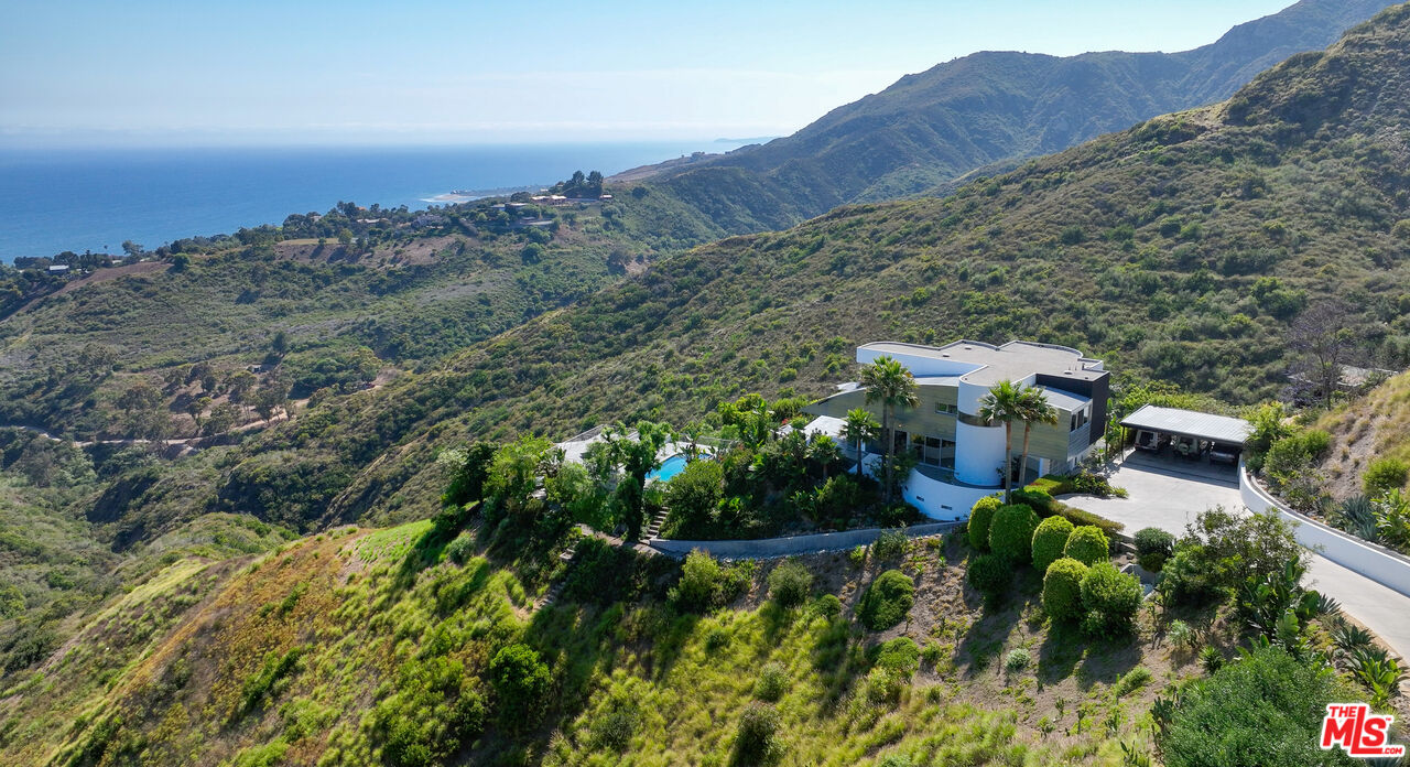 an aerial view of a house with mountain view