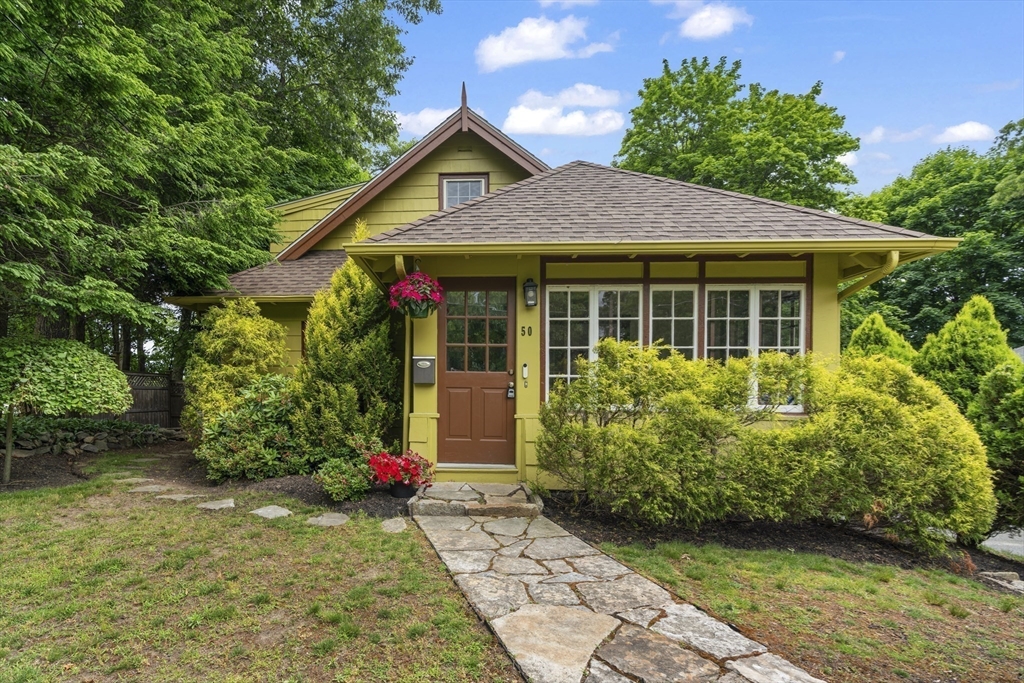 a front view of a house with garden