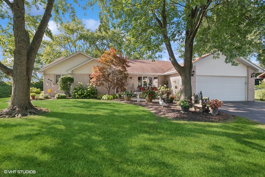 a front view of a house with patio and garden