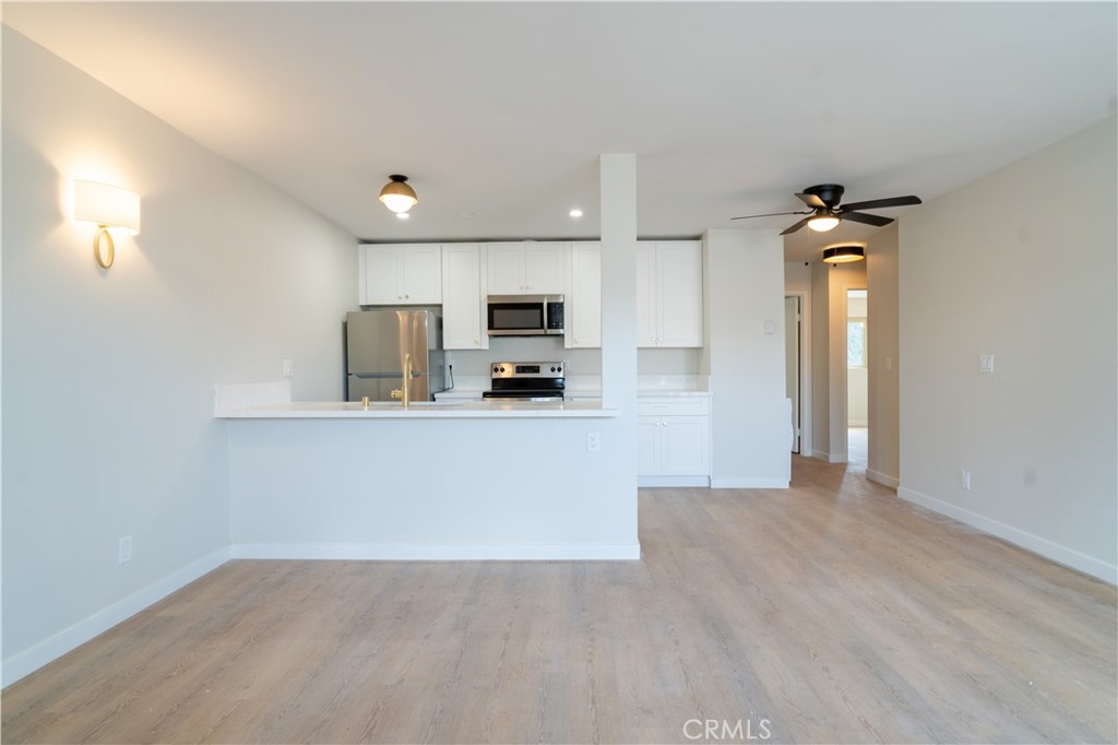 a view of a kitchen with microwave and cabinets