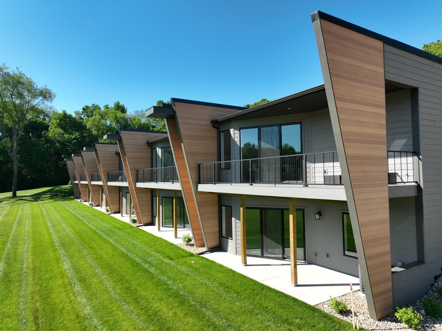 a view of an house with backyard space and balcony