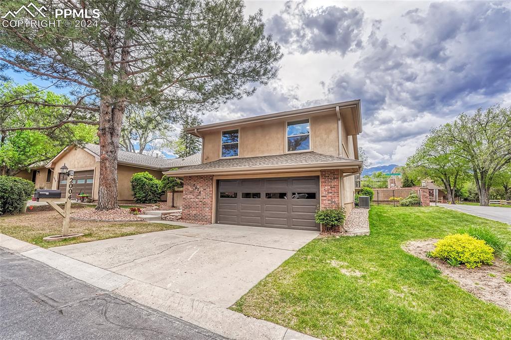 View of front of house with a front yard and an oversized 2 car garage