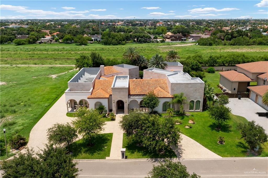 an aerial view of a house with big yard