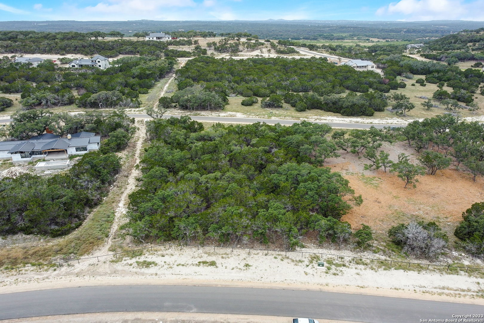 an aerial view of a house with a yard