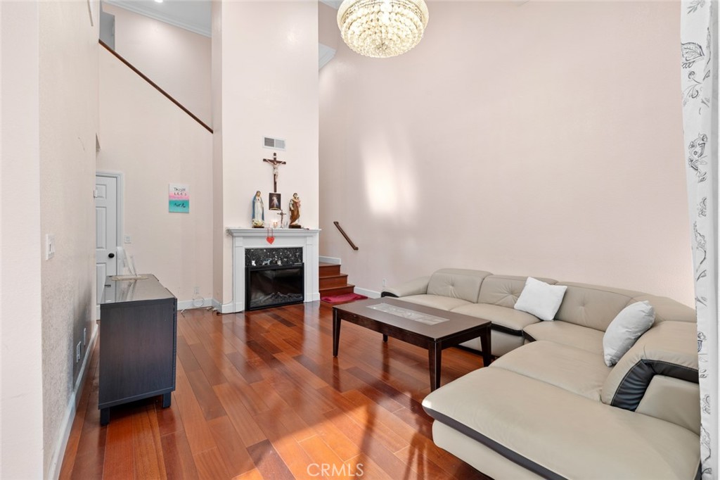 a living room with furniture and a chandelier