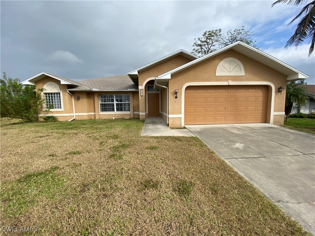 a front view of a house with a yard and garage