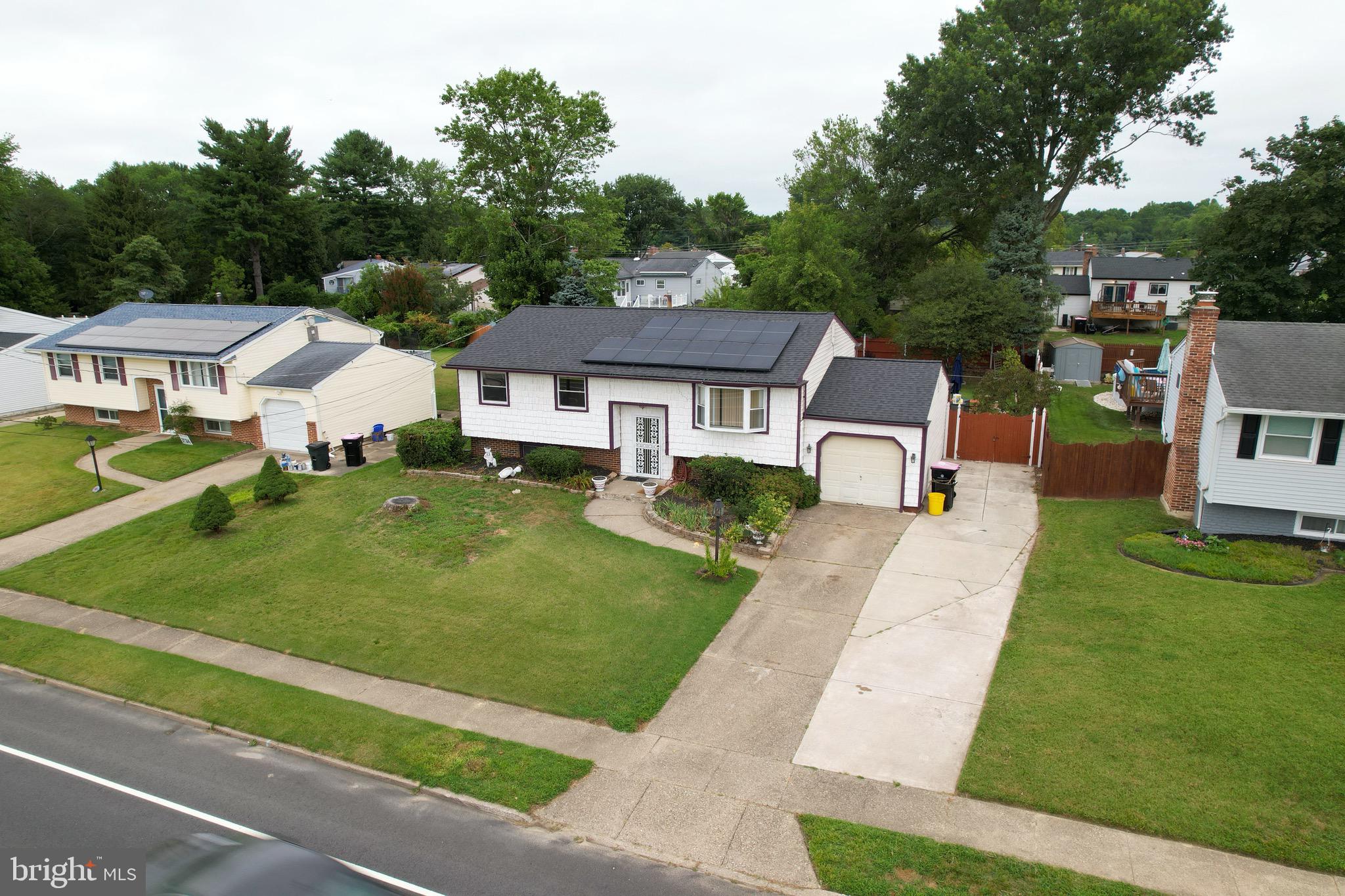 a aerial view of a house with a garden and trees