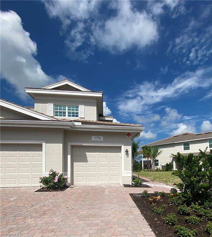 a front view of a house with a yard and garage