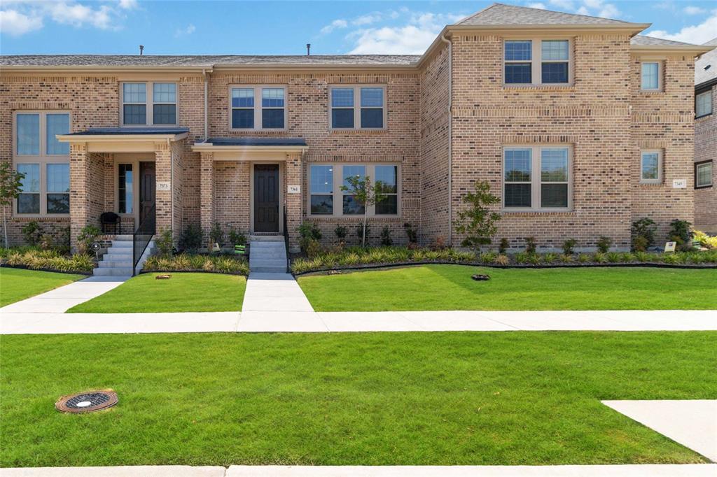 a view of a brick house with a yard