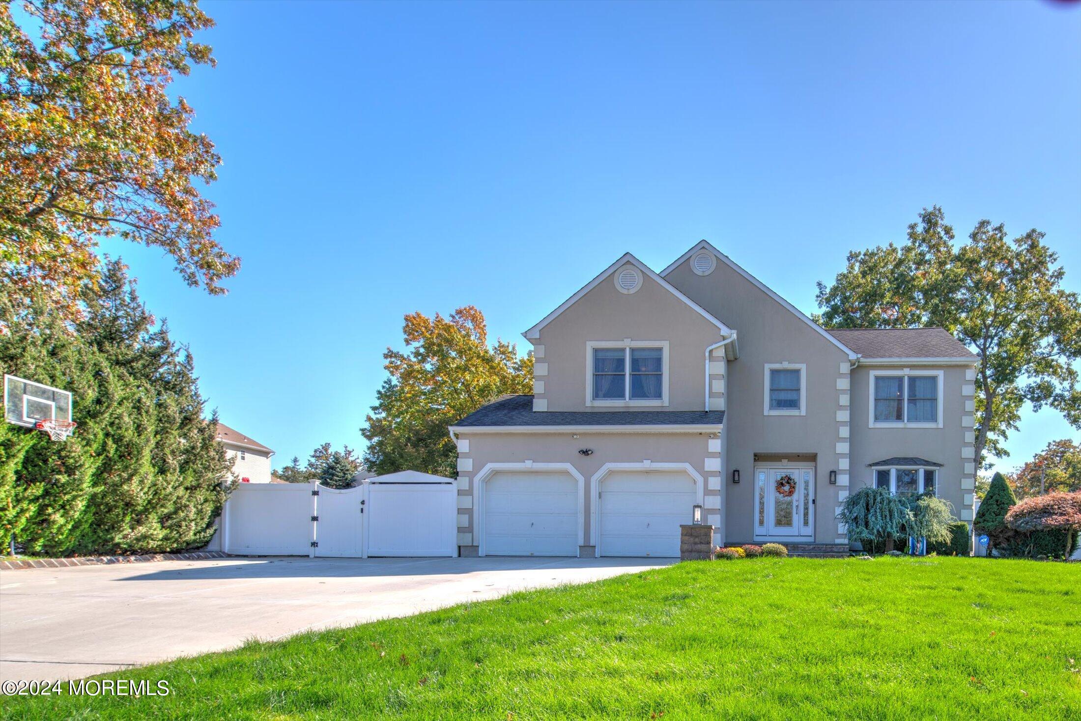 a front view of house with yard and green space