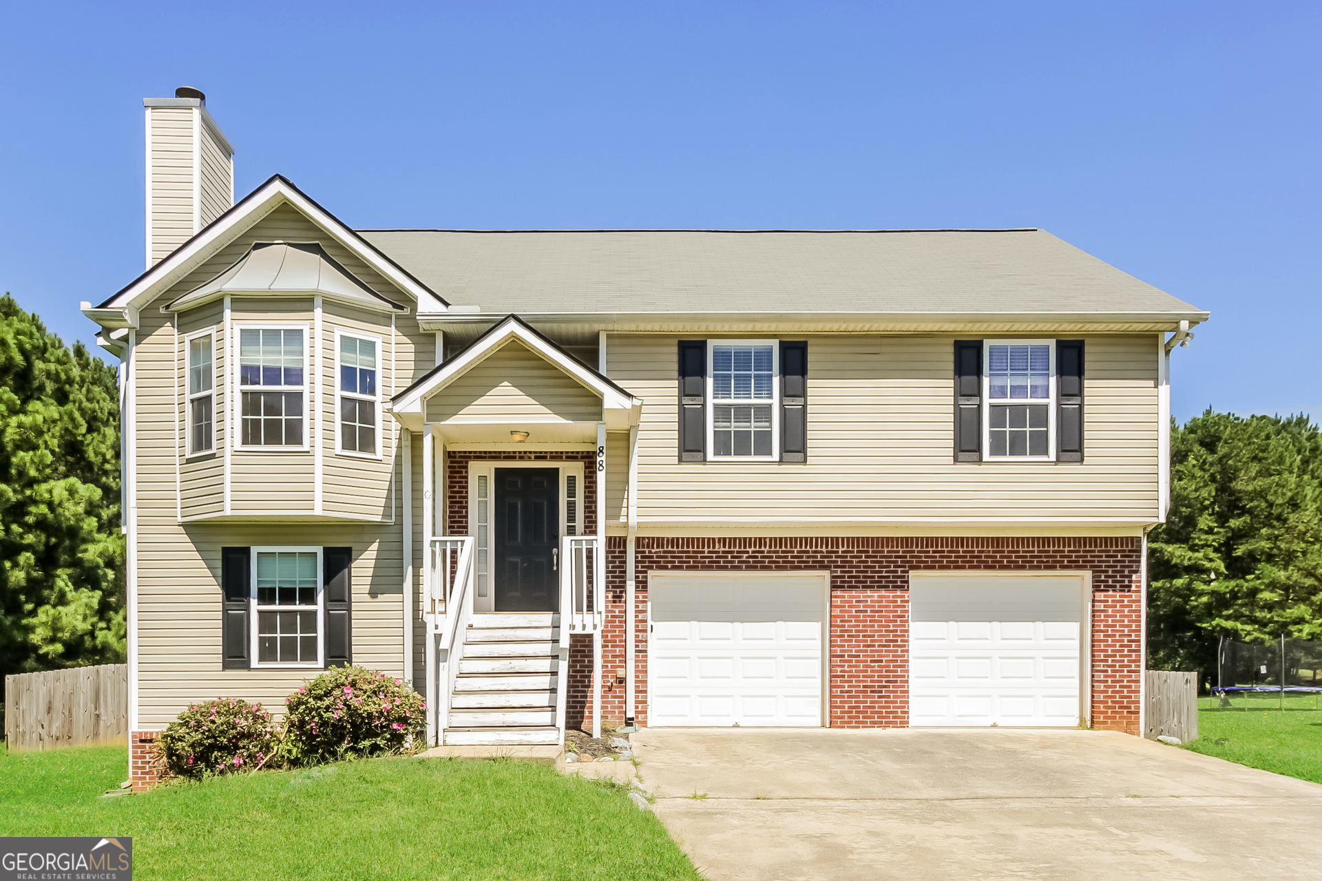 a front view of a house with a yard and garage