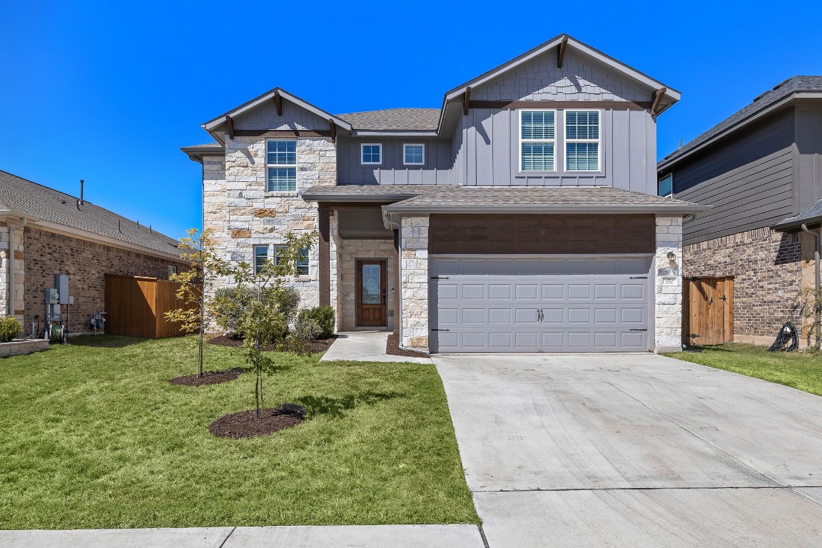 a front view of a house with a yard and garage