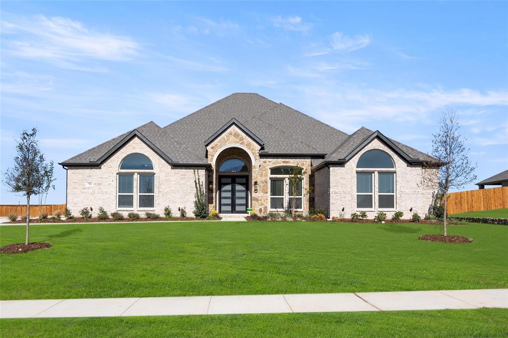 a front view of house with yard and green space