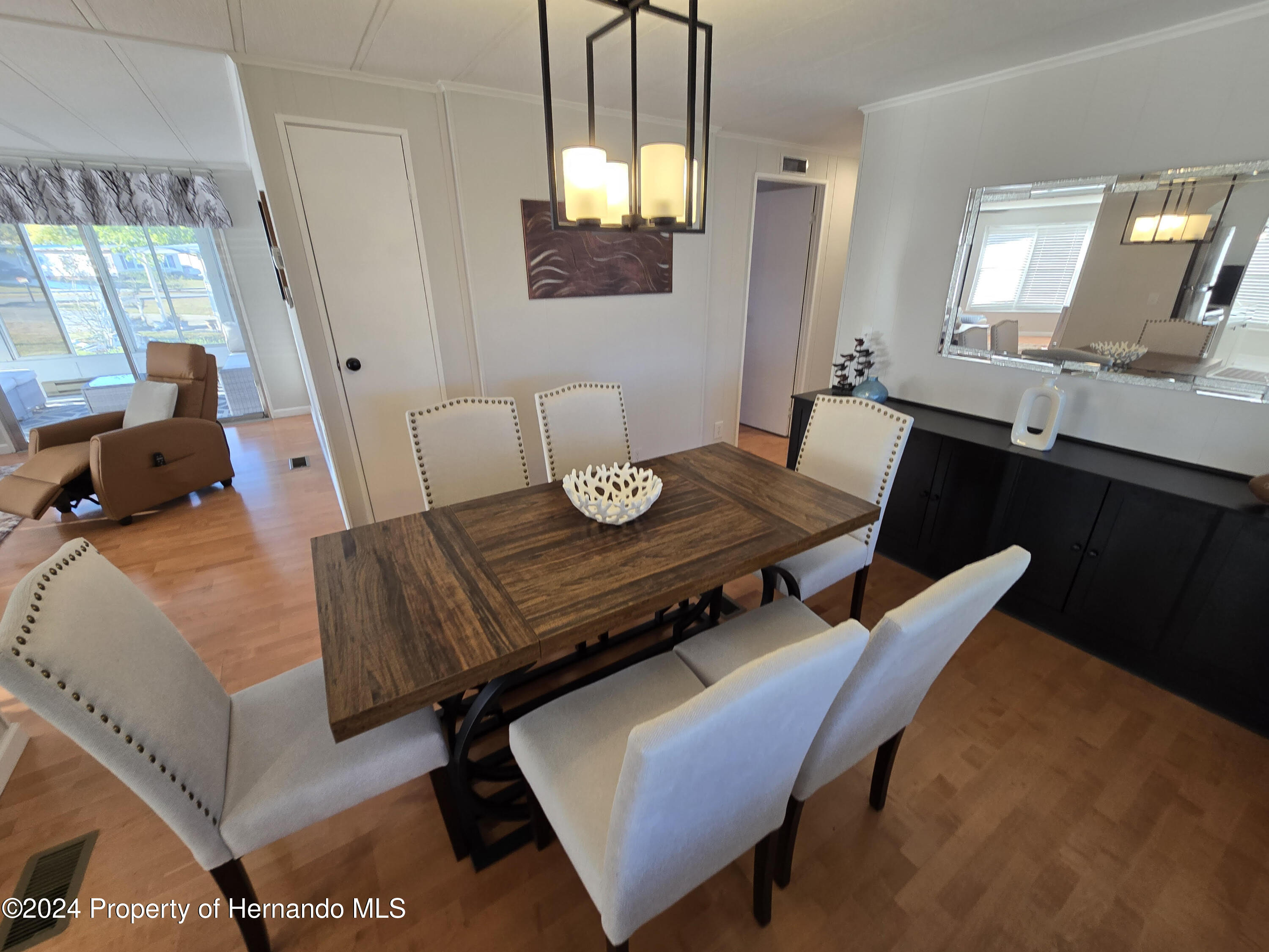 a view of a dining room with furniture and a window