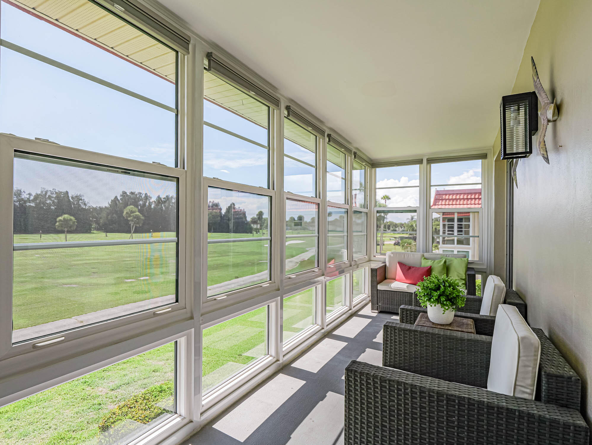 a living room with furniture and a floor to ceiling window