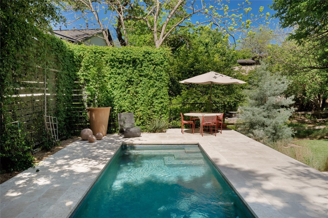 a view of a patio with chairs and plants