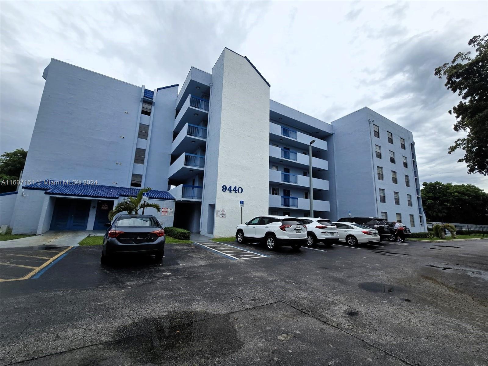 a car parked in front of a white building