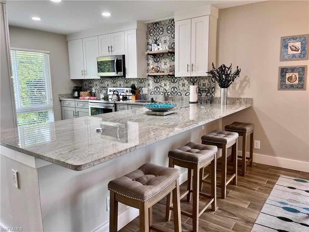 a kitchen with granite countertop lots of counter top space and furniture