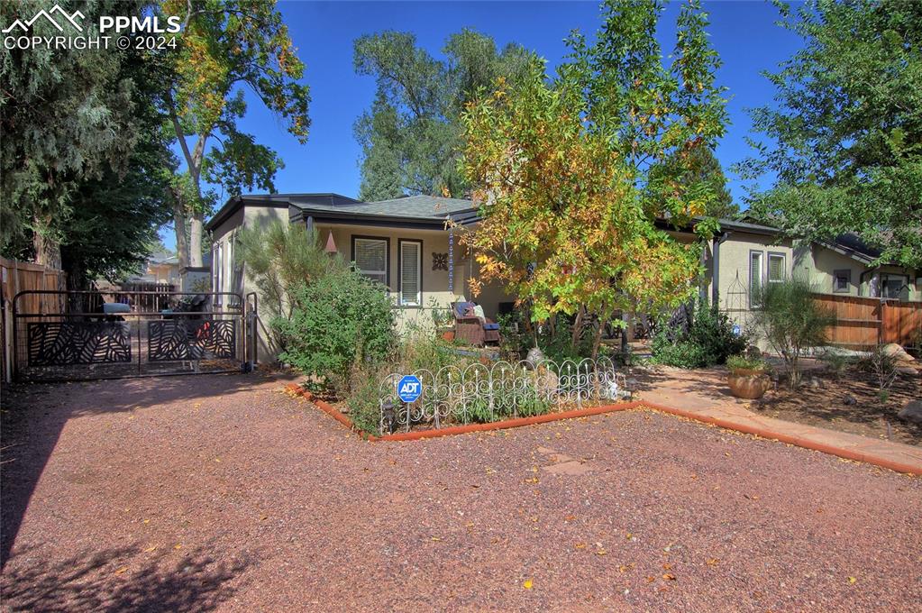 a view of a house with porch and garden